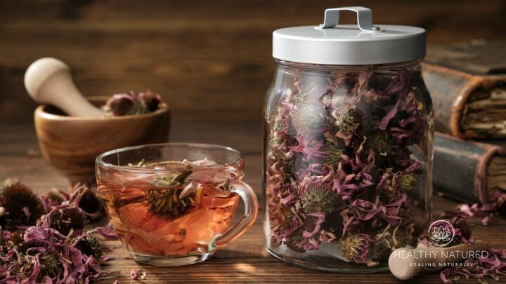a cup of echinacea herbal tea beside a jar of dried echinacea