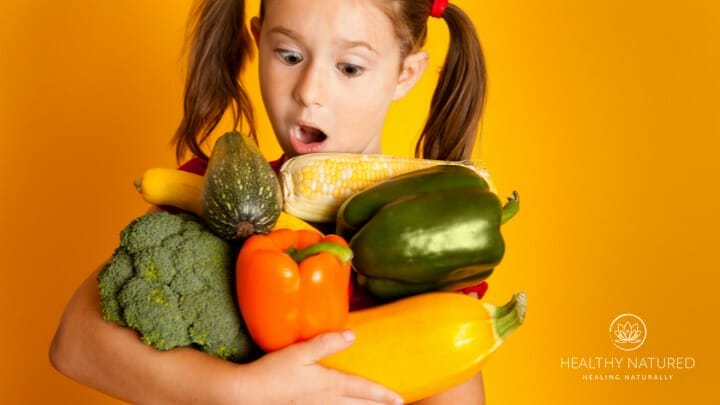young girl holding vegetables that can be used as home remedies for flu symptoms