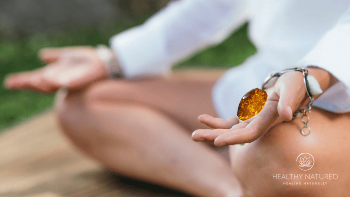 meditating with amber healing crystal