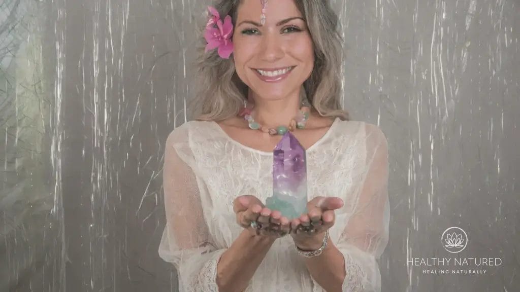 holding a fluorite crystal